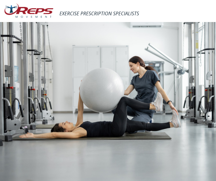 REPS Exercise Physiologist Assisting Woman Exercising with Fitness Ball
